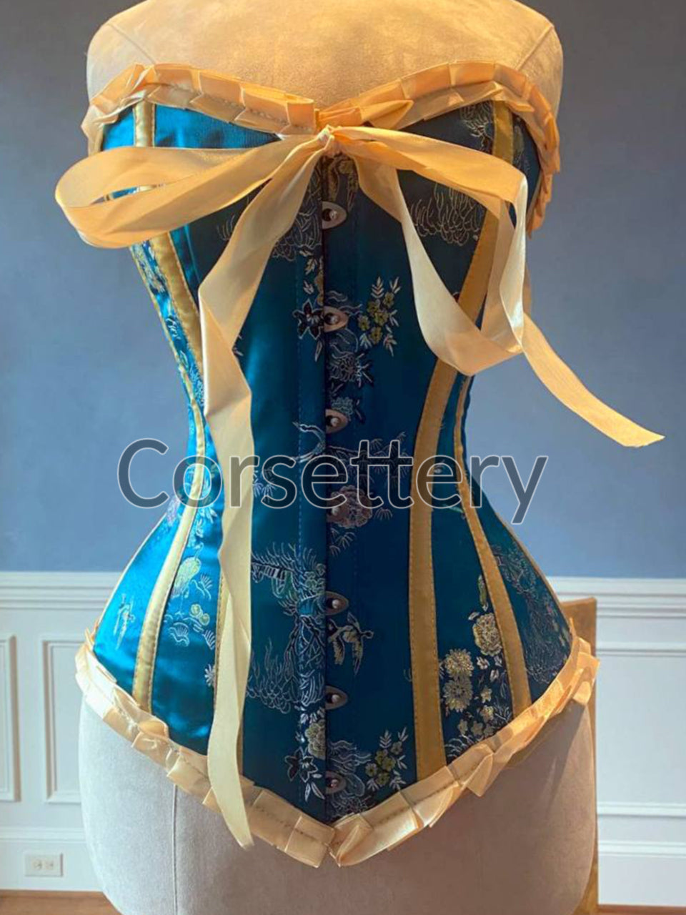 Bright blue brocade steampunk corset with ribbons and bow. Steel
