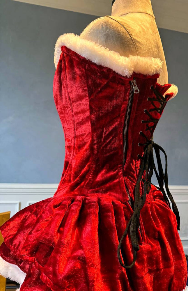 
                  
                    Abito corsetto autentico di Babbo Natale con gonna soffice, abito rosso in velluto natalizio. Mini abito di Babbo Natale
                  
                