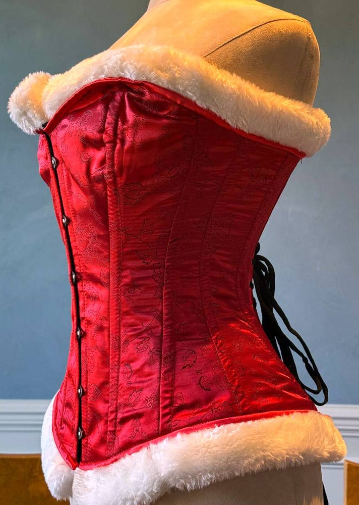 
                  
                    红色锦缎配白色毛皮，价格实惠的圣诞老人紧身胸衣。紧身胸衣根据您的尺寸量身定制。
                  
                