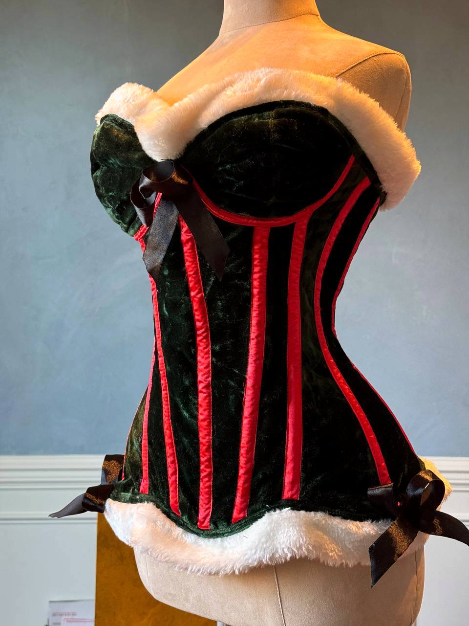 
                  
                    Green velvet Christmas Elf corset with white fur and cups. Corset is made personally according to your measurements.
                  
                