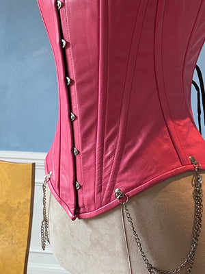 Salmon color leather corset vest with shoulder straps and chains. Steel-boned corset top for tight lacing. Corsettery