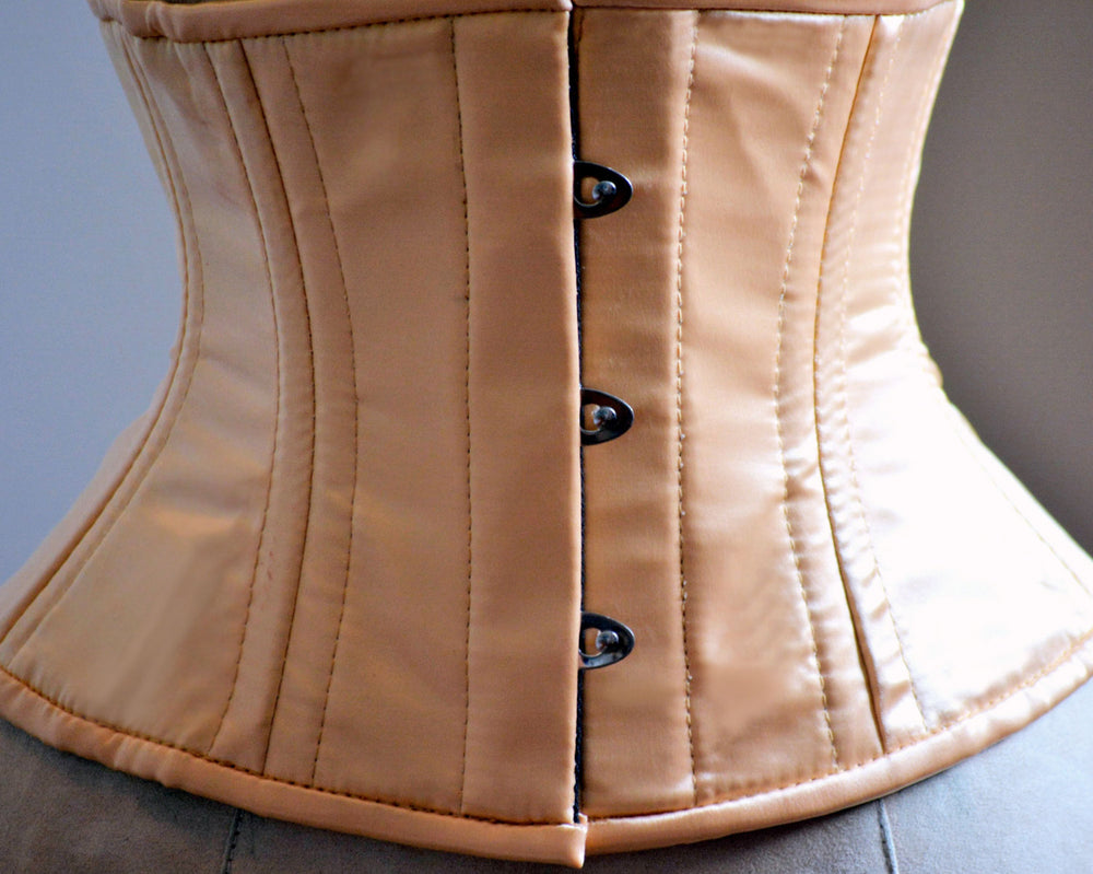 Short nude satin steelboned authentic waspie corset for tight lacing. Steel boned satin corset belt