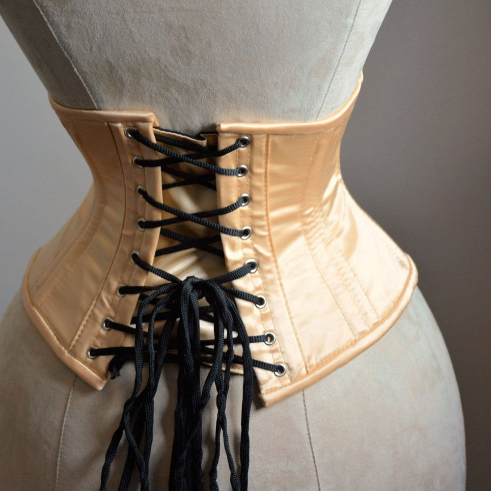 
                  
                    Short nude satin steelboned authentic waspie corset for tight lacing. Steel boned satin corset belt Corsettery
                  
                