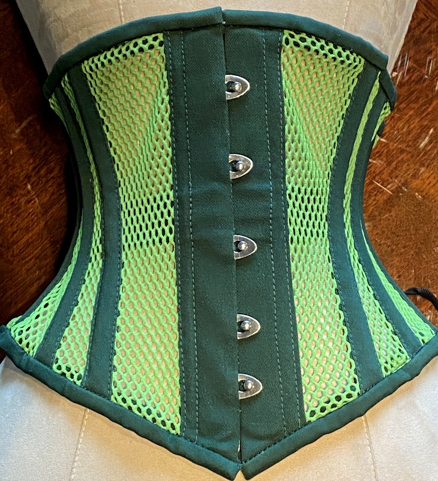 
                  
                    Real steel boned underbust underwear green corset from transparent mesh and cotton. Real waist training corset for tight lacing. Corsettery
                  
                