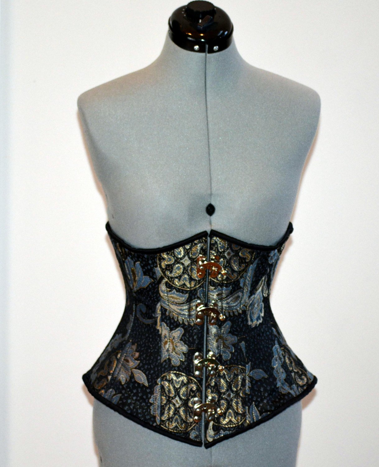 
                  
                    Steel boned underbust steampunk corset from brocade with golden pattern with steampunk hooks. Real waist training corset for tight lacing. Corsettery
                  
                